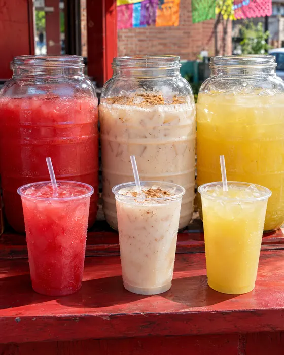 Aguas frescas in big glass jars: watermelon, horchata and pineapple.