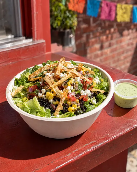 Cilantro Lime Fiesta salad with a cup of dressing.