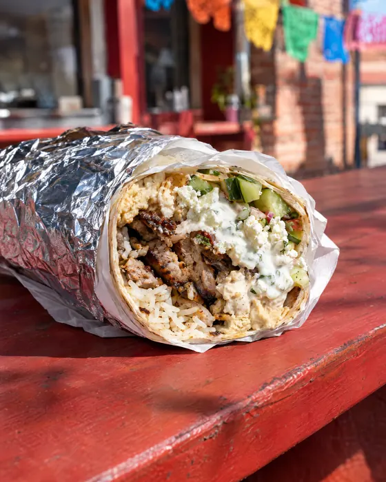 Habibi Burrito cut open to show grilled kebab and rice.