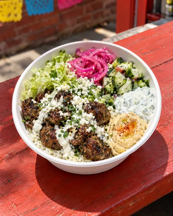 Yalla Bowl with kofta, rice, hummus and pickled onions.
