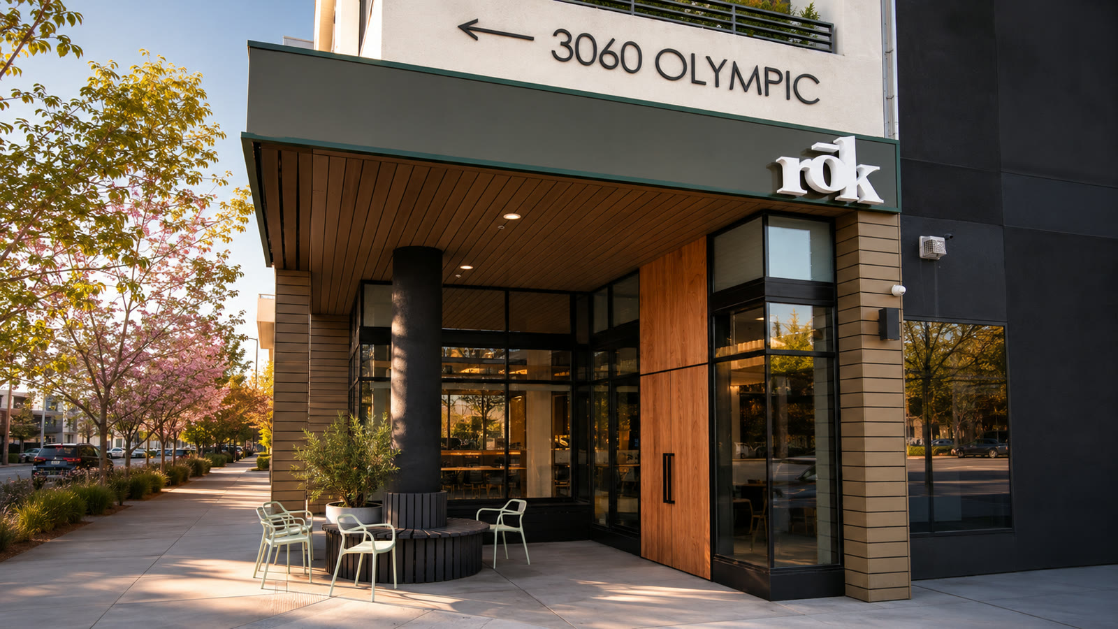The rōk storefront at 3060 W Olympic Blvd, with patio chairs under the wood-lined entrance
