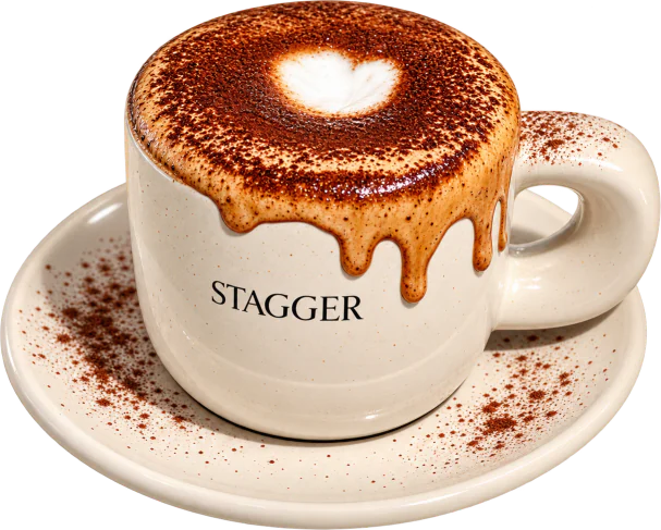 Donut Latte in a Stagger ceramic mug, cream and cacao dripping down the side onto the saucer