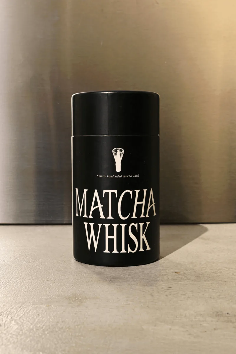 Black Stagger matcha whisk tube on a steel surface